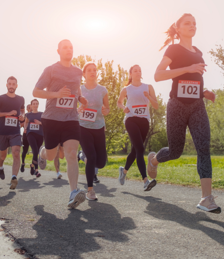 A group of runners with a sunset in the background.